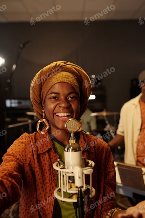 Preview: Smiling African American Woman Using Microphone in Music Studio