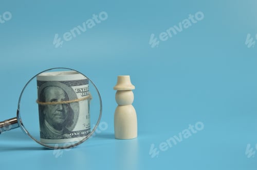 Preview: Wooden figure of people with money banknotes. Leadership concept.