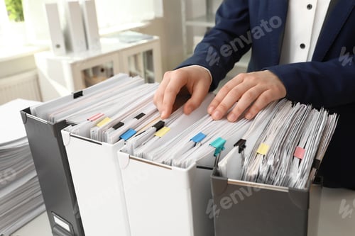 Preview: Woman taking documents from folder in archive, closeup