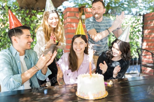 Preview: Smiling Hispanic Woman Celebrating Birthday With Friends