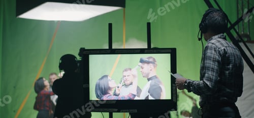 Preview: Medium Shot Of A Director Giving Instructions To Film Crew Member While Actors Preparing In The