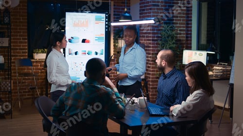 Preview: Diverse women coaching company team in business meeting
