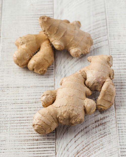 Preview: Fresh ginger on a light wooden background. Seasoning
