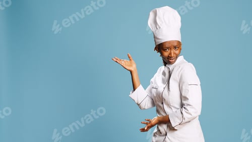 Preview: Professional cook in apron pointing left or right sides