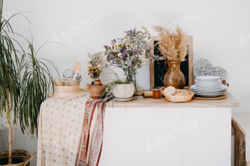 Preview: Home kitchen rustic interior decor of apartment with table, clay and wooden utensil, flowers, home