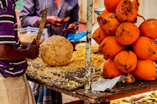 Preview: Preparing of a coconut for drinking on a Colombo market at Sri Lanka