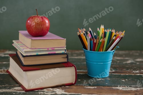 Preview: Apple on stack of books with pen holder