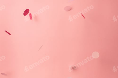 Preview: Pink confetti on pink background. Copyspace for text. Bright and festive holiday background.