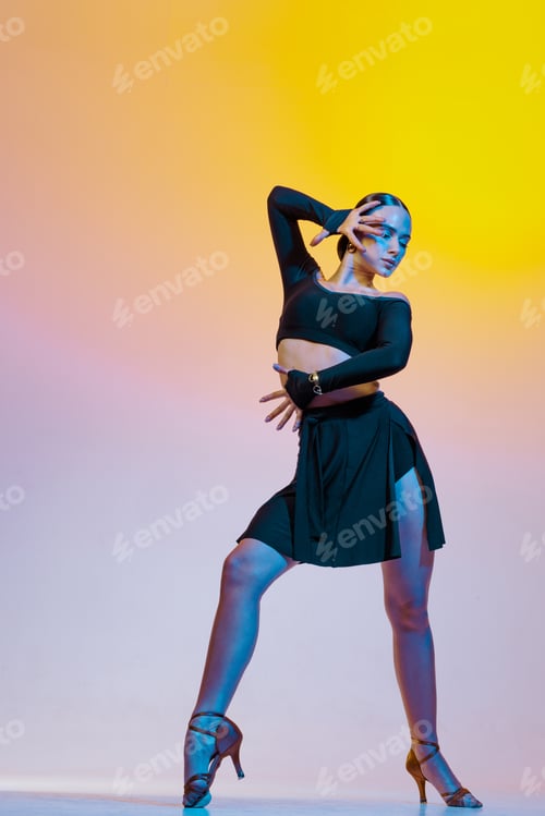 Preview: Graceful dancer in black clothes dances Latin American dances on a bright gradient background.