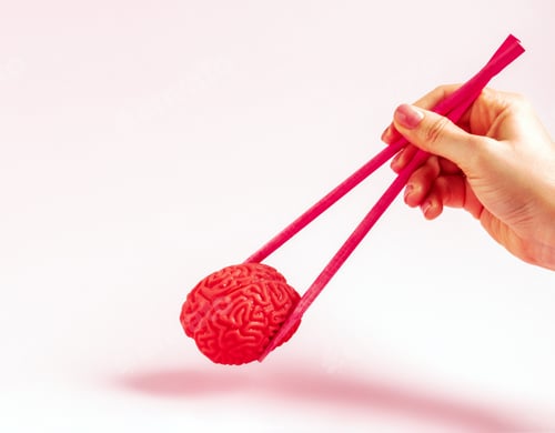 Preview: Human hand holding human brain with two chopsticks. Creative concept.