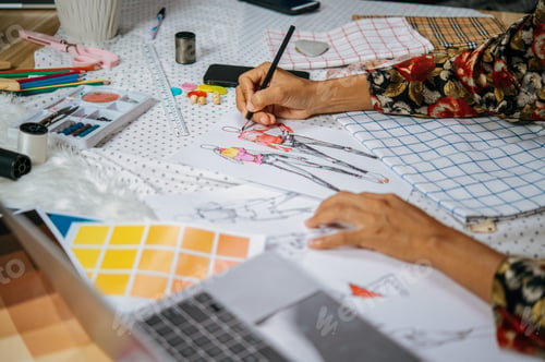 Preview: Young designer use laptop during drawing clothes sketch