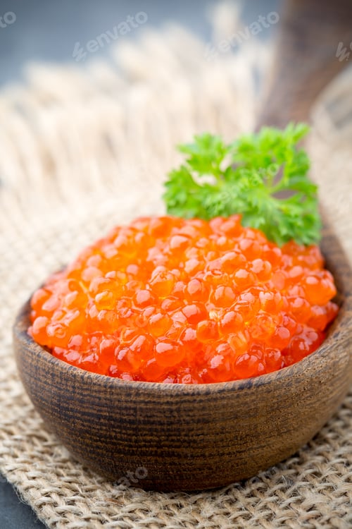 Preview: Salmon caviar with spoon on gray background.