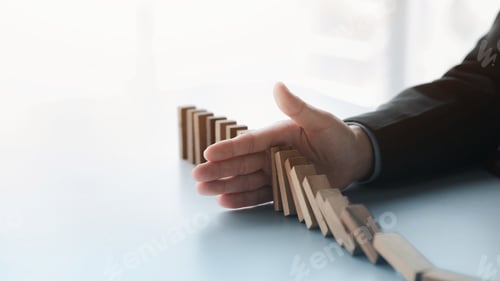 Preview: A close-up shot of a businessman holding the wooden blocks in a row.