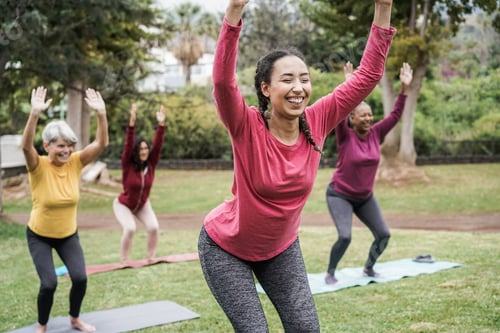 Preview: Multi generational people doing yoga class keeping at city park - Focus on center girl face
