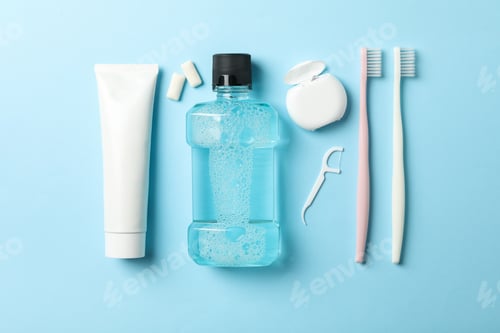 Preview: Flat lay with tools for dental care on blue background