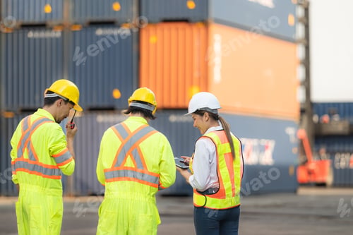 Preview: Group of workers in the import and export industry use walkie talkies to communicate