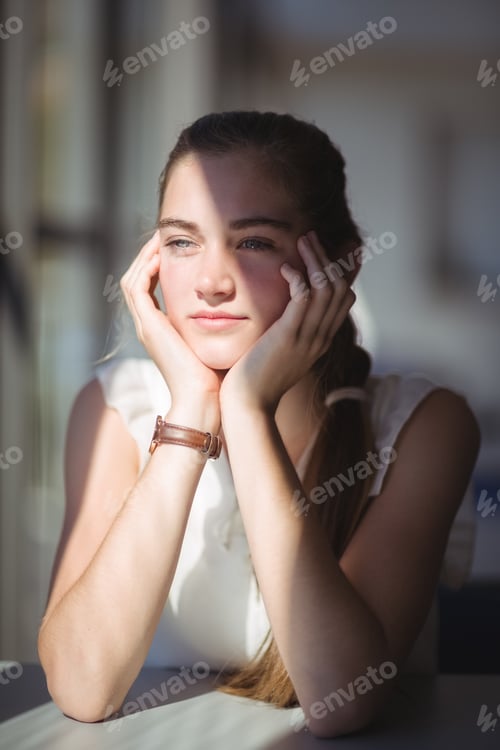 Preview: Thoughtful schoolgirl sitting in classroom