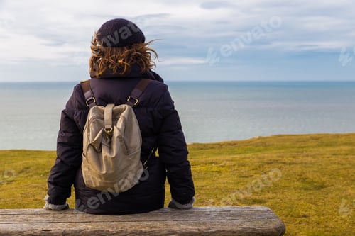 Preview: rearview of a woman in front of beach