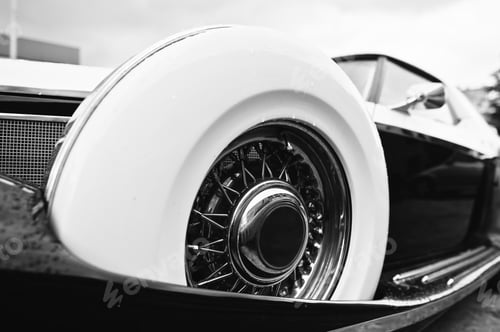 Preview: Vintage wheel at retro car. Black and white photo