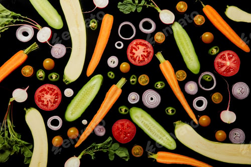 Preview: top view of fresh organic sliced vegetables isolated on black