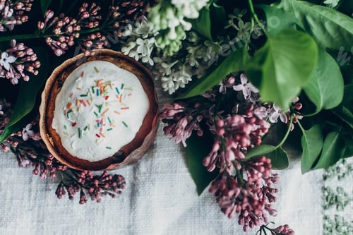 Preview: easter cake and colorful decorated eggs on rustic background with lilac flowers