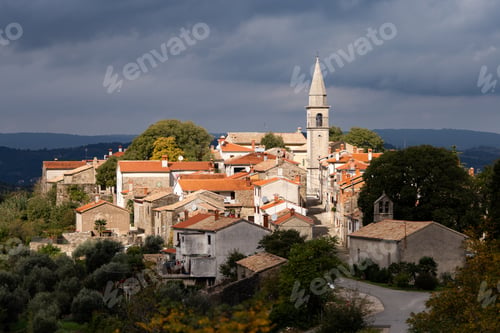 Preview: High angle shot of the Draguc village in Croatia under the dark cloudy sky