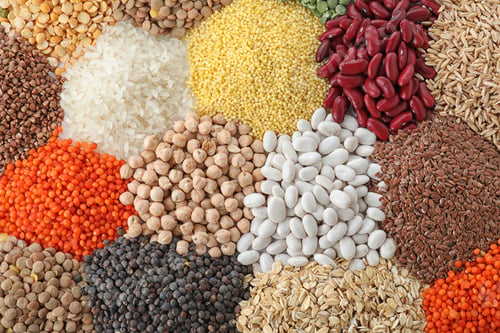 Preview: Different types of legumes and cereals as background, top view. Organic grains