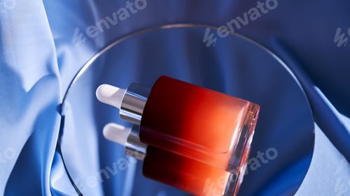 Preview: Bottle with pink serum on a blue background.