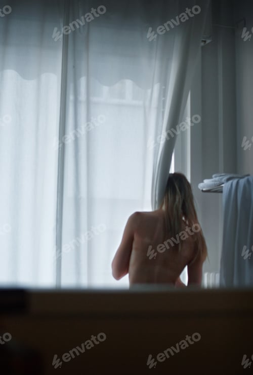 Preview: Woman in Bathroom with Morning Light Streaming In