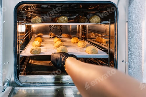 Preview: Person baking cookie dough in commercial oven