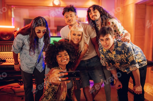 Preview: Band mates taking a photo together with music producer and audio technician.