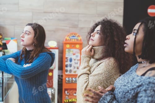 Preview: three young women multiethnic indoor staring