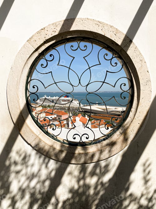 Preview: Shadow in the form of parallel diagonals on a wall with a round window overlooking the Lisbon port
