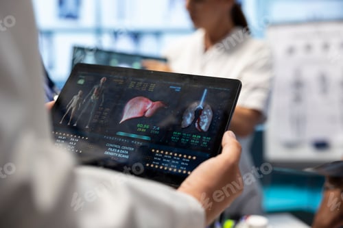 Preview: Professional doctor analyzing lungs and liver radiography test result