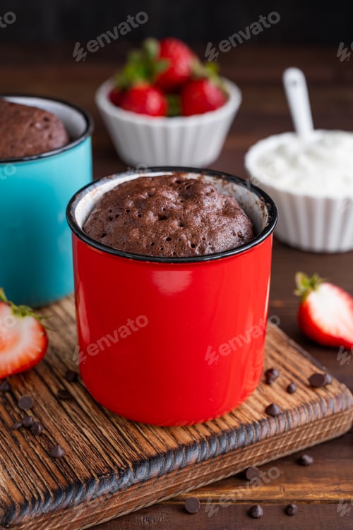 Preview: Chocolate mug cake with whipped cream and fresh berries. Cupcake cooked in the microwave.