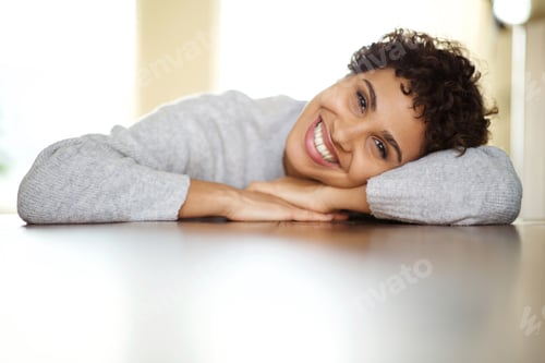 Preview: Close up beautiful young african american woman smiling with head relaxing on arms