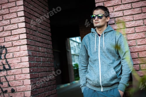 Preview: Portrait of a young man with glasses on the street