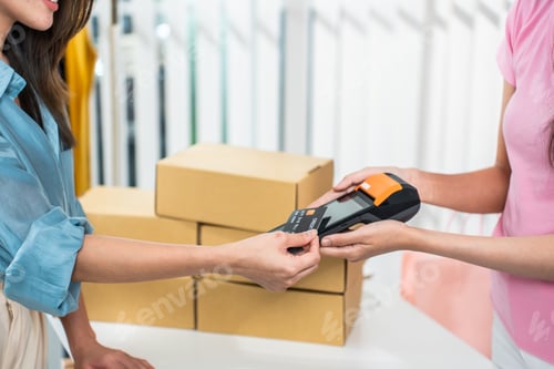 Preview: Close up hands of young woman use credit card pay for vase goods order.
