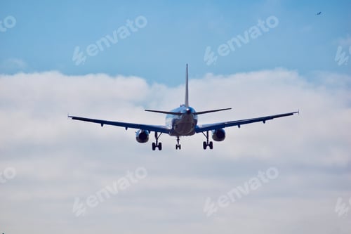 Preview: Awesome angle on an airplane coming in from the clouds for a landing while another in the upper