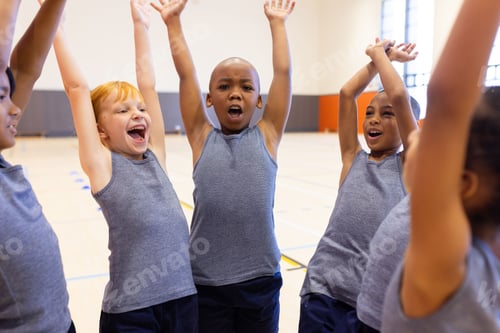 Preview: In school gym, diverse children cheering and raising hands, enjoying physical education class