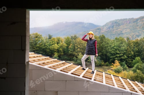Preview: Young woman worker on the construction site.