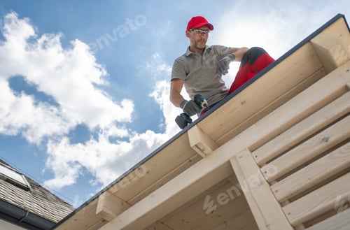 Preview: Construction Worker on Roof Using Drill