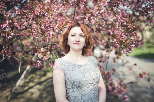 Preview: Cheerful Armenian woman under the blooming sakura