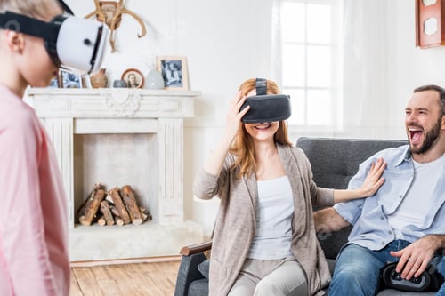 Preview: Happy family using virtual reality headsets at home
