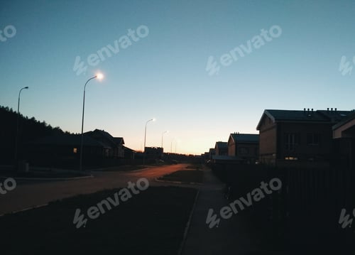 Preview: View of the night street with beautiful cozy houses, cottage village