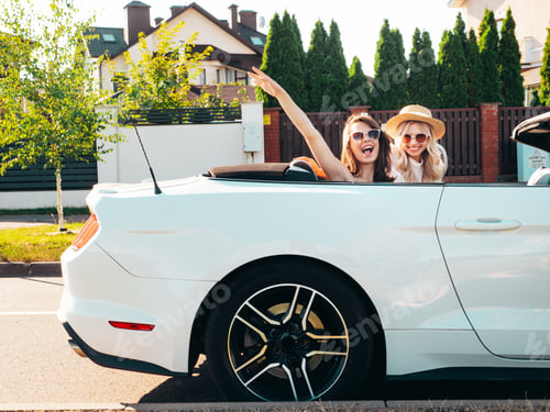Preview: Two beautiful women enjoying summer days with cabriolet