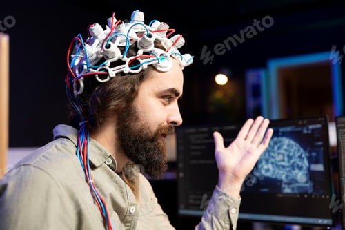 Preview: Smiling technician using EEG headset to upload consciousness into computer