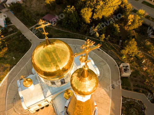 Preview: aerial close up religion cross on top of amazing golden church architecture during sunset f