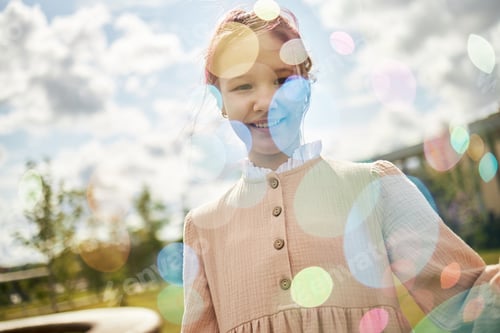 Preview: Portrait of Caucasian Girl Smiling Outdoors Surrounded by Colorful Light Effects