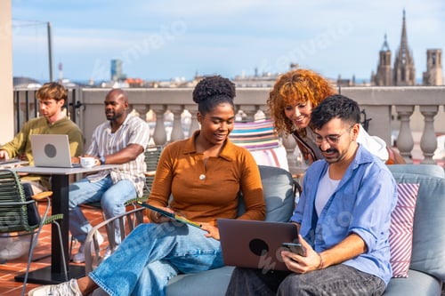 Preview: Diverse colleagues working and collaborating on a rooftop terrace